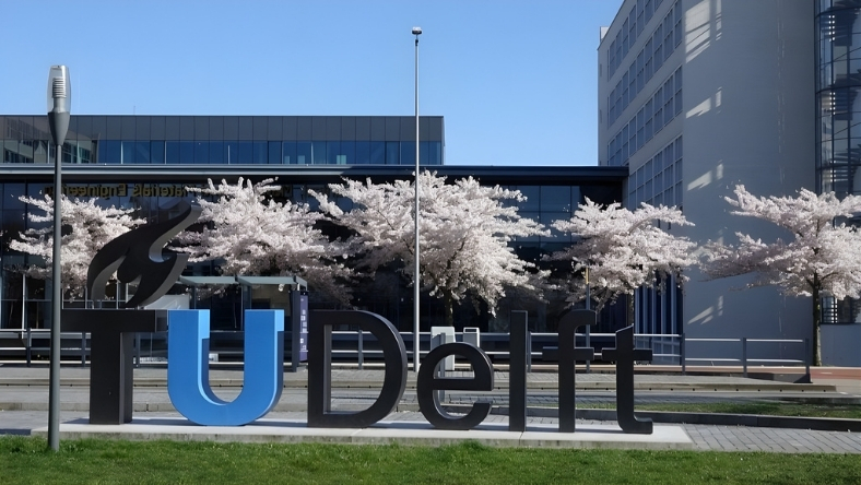 TU Delft university sign outside modern building
